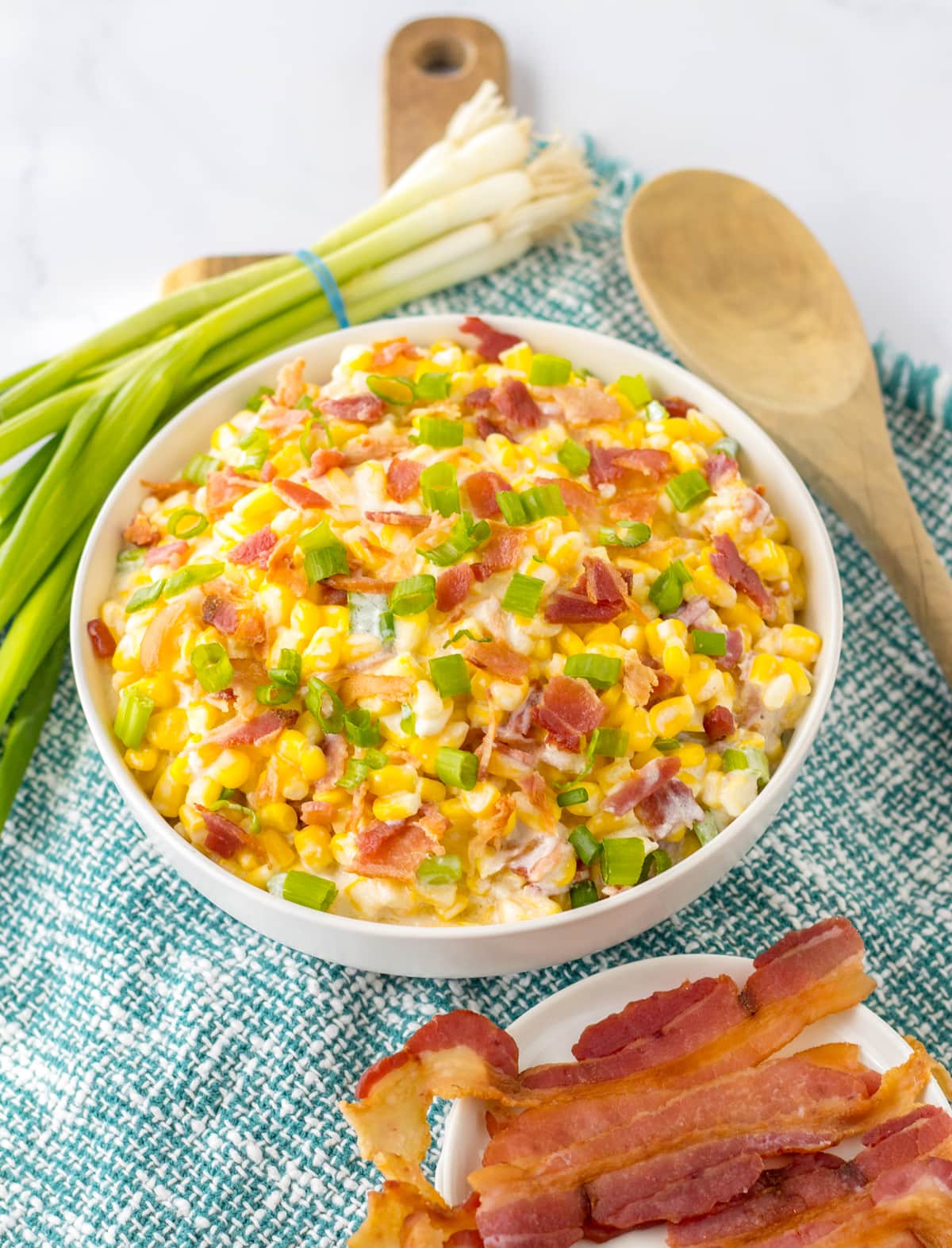 crock pot creamed corn with bacon in white bowl