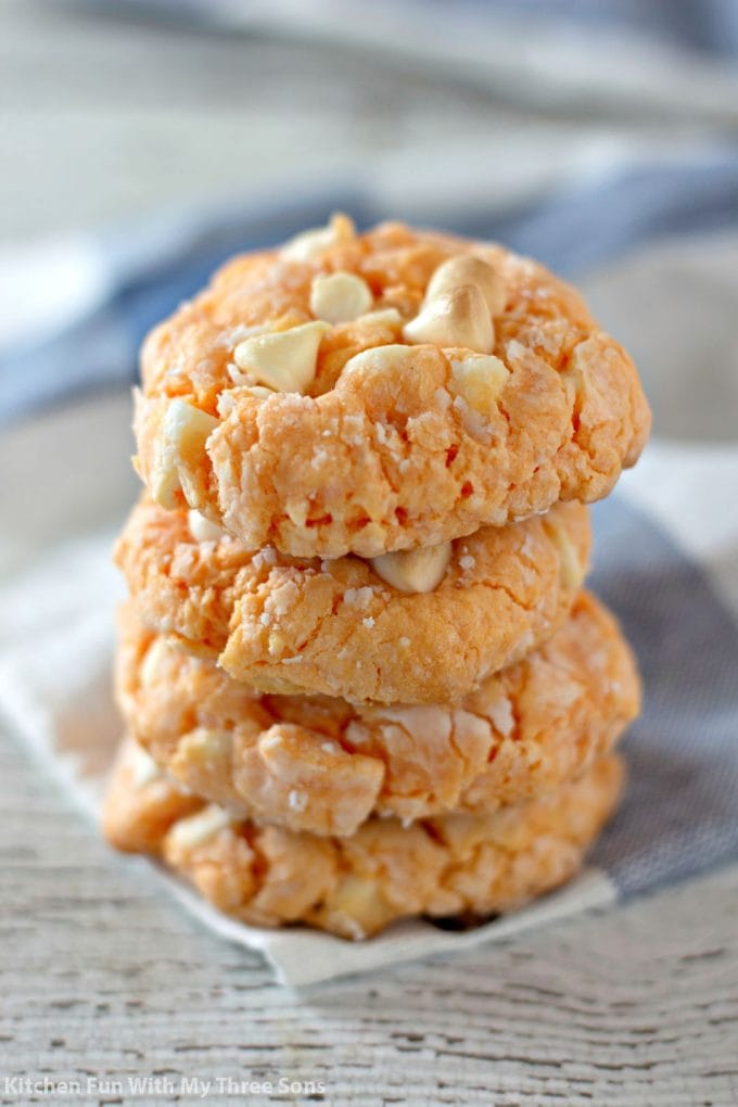 a stack or Orange Creamsicle Cake Mix Cookies on a blue and white napkin