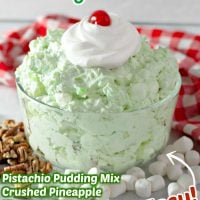 Title image for Watergate Salad featuring Watergate salad in a clear bowl topped with whipped cream and a cherry.